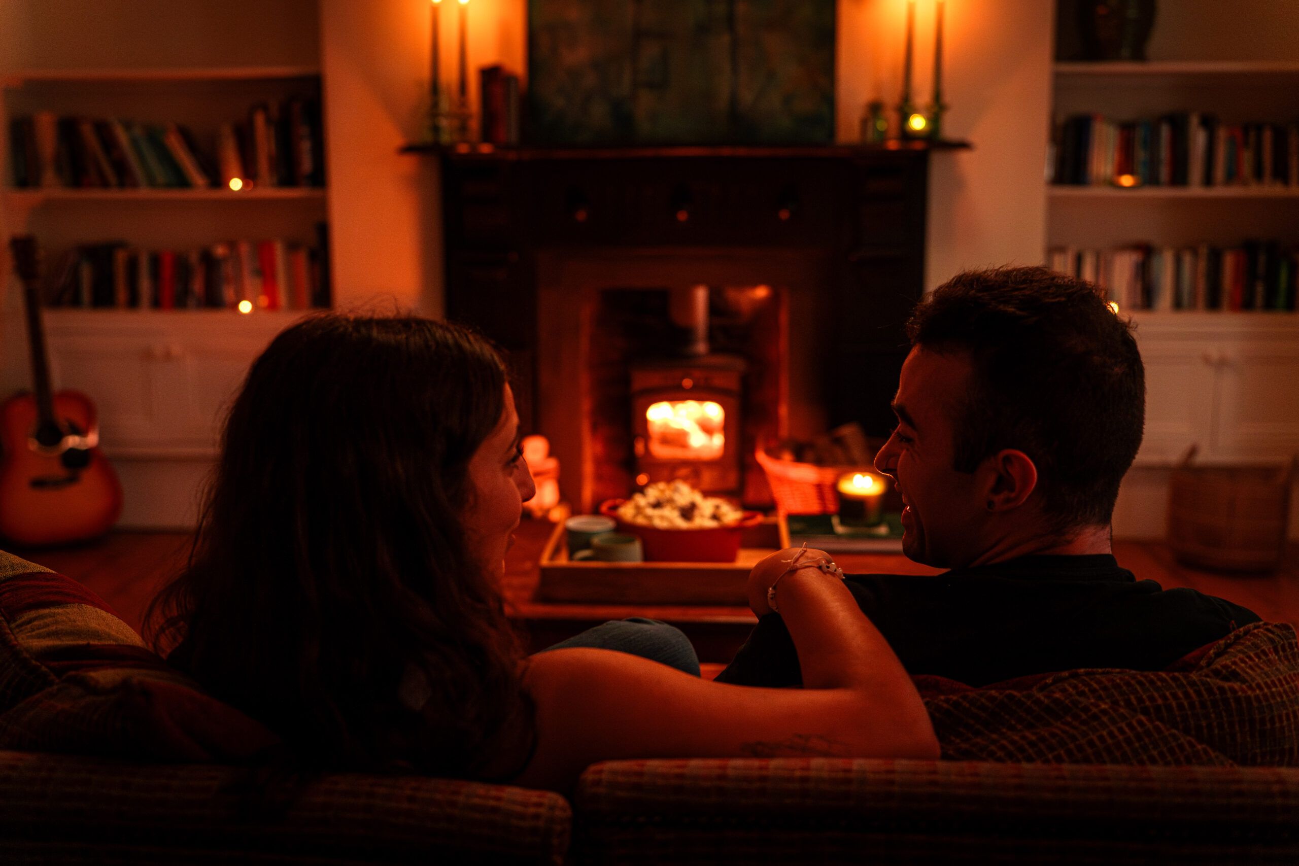 Couple chatting in front of a fire