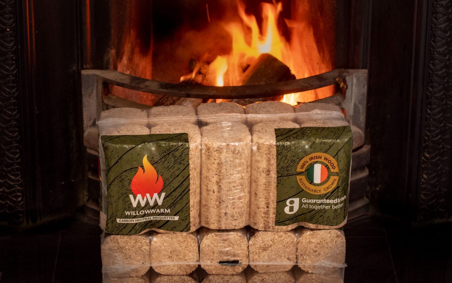 WillowWarm Briquette bales sitting in front of an open fire