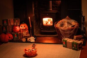 A fire with halloween decorations either side of it