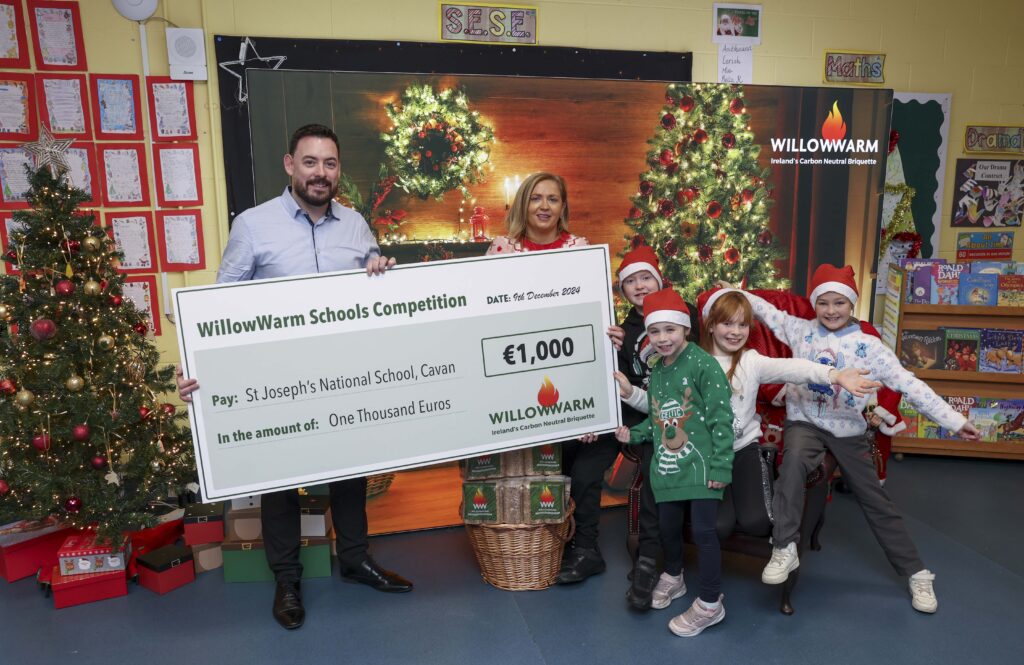 Alan Breslin from WillowWarm presenting a cheque to the teacher and pupils of St. Joseph's NS