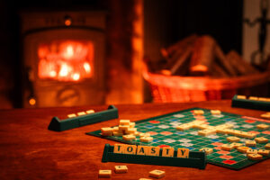 Scrabble game with TOASTY spelt out and a fire in the background