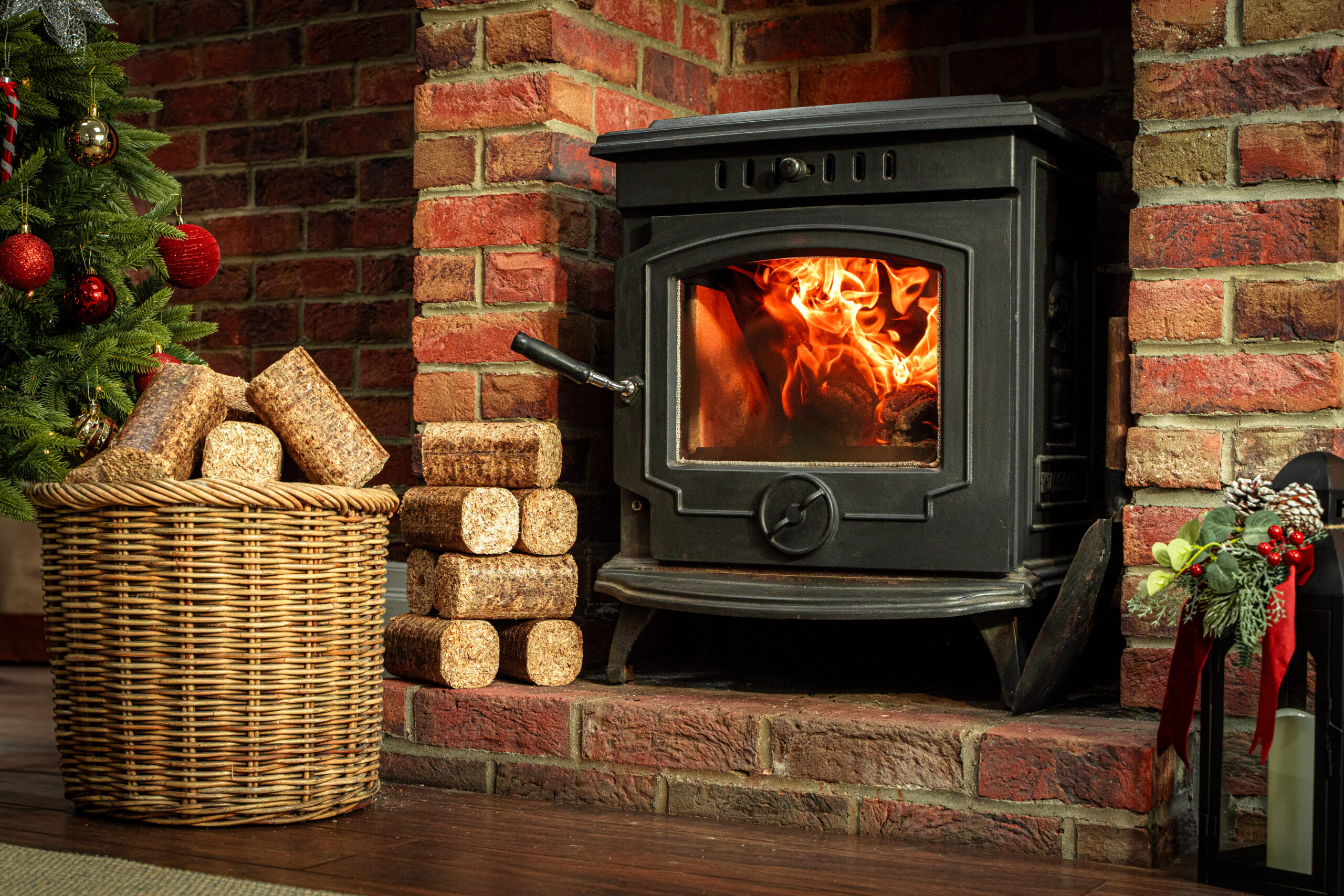 WillowWarm Briquettes sitting on a wooden bench with a burning fire in the background