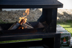 WillowWarm briquettes burning in an outdoor fire pit WillowWarm carbon-neutral briquettes burn perfect in outdoor stoves and fire pits all year round
