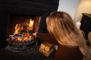 Topping up a fire with WillowWarm Briquettes Topping up a fire with WillowWarm Briquettes