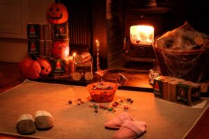 Halloween Movie Recommendations. Living room with fire and halloween decorations. Cosy night in This Halloween.